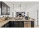 Kitchen with granite counters, stainless dishwasher, and view of the living area with natural light and pendant lighting at 12244 Fairlawn Dr, Riverview, FL 33579