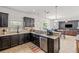 Open kitchen boasts granite countertops, stainless appliances, dark wood cabinets and seamless flow into the living area at 12244 Fairlawn Dr, Riverview, FL 33579