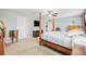 Spacious main bedroom featuring a four-poster bed, ceiling fan and neutral decor at 12244 Fairlawn Dr, Riverview, FL 33579