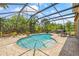 Inviting screened-in pool area with a uniquely shaped pool and ample seating at 12244 Fairlawn Dr, Riverview, FL 33579