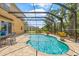 Lush landscaping surrounds this screened-in pool perfect for entertaining and relaxation at 12244 Fairlawn Dr, Riverview, FL 33579