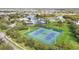 Aerial view of community tennis courts surrounded by lush greenery, showcasing recreational amenities near the homes at 12244 Fairlawn Dr, Riverview, FL 33579