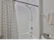 Bright bathroom features a shower over tub, white tiles, and a modern shower head at 12382 Shining Willow St, Riverview, FL 33579