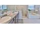 Beautiful bathroom features a double sink vanity, a glass shower stall and a soaking tub at 12382 Shining Willow St, Riverview, FL 33579
