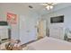 Bright bedroom with modern ceiling fan, walk-in closet, and wood-look flooring at 12382 Shining Willow St, Riverview, FL 33579