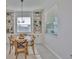 Dining area features built-in shelving, a round table, and natural light from two windows at 12382 Shining Willow St, Riverview, FL 33579