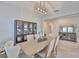 Elegant dining room with modern light fixture, stylish chairs, and ample natural light at 12382 Shining Willow St, Riverview, FL 33579