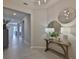 Bright entryway featuring tile floors, tray ceilings, decorative mirrors, and stylish console table at 12382 Shining Willow St, Riverview, FL 33579