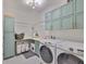 Convenient laundry room with ample storage in the shaker cabinets and included washer and dryer at 12382 Shining Willow St, Riverview, FL 33579