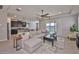 Open concept living room boasts a ceiling fan, rug, and sliding glass doors to the outdoor space at 12382 Shining Willow St, Riverview, FL 33579