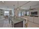 Open living space connects the kitchen island, dining area, and living room for easy gathering at 12382 Shining Willow St, Riverview, FL 33579