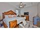 This primary suite offers a trey ceiling, furniture with wood trim, and a TV at 12382 Shining Willow St, Riverview, FL 33579