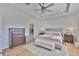 Main bedroom features a tray ceiling, ensuite bath, and a neutral color palette for a relaxing retreat at 12382 Shining Willow St, Riverview, FL 33579