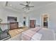 This main bedroom has wood floors, ceiling fan, and access to the bathroom and walk-in closet at 12382 Shining Willow St, Riverview, FL 33579