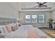 Lovely main bedroom featuring tray ceilings, wood floors, and large windows for ample natural light at 12382 Shining Willow St, Riverview, FL 33579