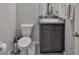 This powder room features modern fixtures, a granite counter top and wood cabinets at 12382 Shining Willow St, Riverview, FL 33579