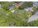 The property aerial shot highlights the house's location surrounded by lush, mature trees and landscaping at 1368 Whispering Pines Dr, Clearwater, FL 33764