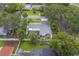 Aerial view highlights a screened-in pool and the home's meticulously maintained outdoor space at 1368 Whispering Pines Dr, Clearwater, FL 33764
