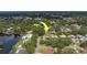 An overhead shot of the home with verdant surroundings, accentuated by a marker indicating the location at 1368 Whispering Pines Dr, Clearwater, FL 33764