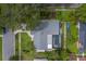 Home features a gray roof, paved driveway, and a screened-in in-ground pool at 1368 Whispering Pines Dr, Clearwater, FL 33764