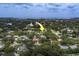 An aerial view of a home nestled within a lush, verdant landscape with marker indicating location at 1368 Whispering Pines Dr, Clearwater, FL 33764