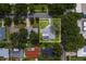 Home sits on a well-maintained lot with mature trees and features a screened-in pool area at 1368 Whispering Pines Dr, Clearwater, FL 33764