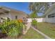 Backyard view with tropical foliage, a jet ski on a trailer, and partial fencing at 1368 Whispering Pines Dr, Clearwater, FL 33764