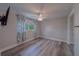 Bedroom features a closet with mirrored doors, a ceiling fan, and hardwood floors at 1368 Whispering Pines Dr, Clearwater, FL 33764