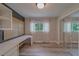 Bedroom with a closet with mirrored doors, built-in desk, and a window at 1368 Whispering Pines Dr, Clearwater, FL 33764