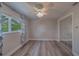 Bedroom features a closet with mirrored doors, a ceiling fan, and hardwood floors at 1368 Whispering Pines Dr, Clearwater, FL 33764