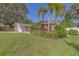 Charming front yard with lush landscaping and a well-maintained lawn at 1368 Whispering Pines Dr, Clearwater, FL 33764