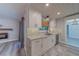 Updated kitchen showcasing white cabinets, stone counters, stylish backsplash, and sleek, modern fixtures at 1368 Whispering Pines Dr, Clearwater, FL 33764
