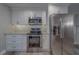 Contemporary kitchen featuring stainless steel appliances, white cabinetry and complementary hardware at 1368 Whispering Pines Dr, Clearwater, FL 33764
