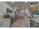Eat-in kitchen with stainless steel appliances, gray tone flooring, and modern kitchen cabinets and finishes at 1368 Whispering Pines Dr, Clearwater, FL 33764