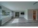 Bright, open living room featuring a large window with gray curtains and sleek flooring at 1368 Whispering Pines Dr, Clearwater, FL 33764