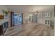 Bright living room with wood floors, sliding glass doors, and a modern chandelier at 1368 Whispering Pines Dr, Clearwater, FL 33764