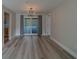Spacious living room with sliding glass doors leading to outdoor area and view of updated kitchen at 1368 Whispering Pines Dr, Clearwater, FL 33764