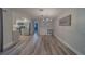 Spacious, open-concept living and dining area featuring kitchen access, modern lighting and gray-tone flooring at 1368 Whispering Pines Dr, Clearwater, FL 33764