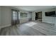Bright living room featuring a large window with gray curtains and sleek flooring at 1368 Whispering Pines Dr, Clearwater, FL 33764
