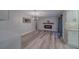 Open floor plan featuring a fireplace, accent lighting, and modern gray-tone flooring at 1368 Whispering Pines Dr, Clearwater, FL 33764