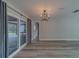 Bright living room features sliding glass doors leading to screened in outdoor patio at 1368 Whispering Pines Dr, Clearwater, FL 33764