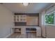 Office with built-in desk and shelves featuring a window with natural light at 1368 Whispering Pines Dr, Clearwater, FL 33764