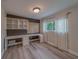 Office space with built-in desk, shelving, and natural light from the window at 1368 Whispering Pines Dr, Clearwater, FL 33764