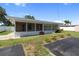 The backyard features a screened-in porch, a bird bath, and a defined area covered in black mats at 13898 Jamaica Dr, Seminole, FL 33776