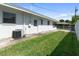 A charming backyard with a well-maintained lawn and the exterior of the home at 13898 Jamaica Dr, Seminole, FL 33776