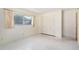 This bedroom offers neutral walls, speckled floor, large closet, and a sunny window at 13898 Jamaica Dr, Seminole, FL 33776
