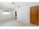 Bedroom featuring speckled floor, neutral walls, a window, and door to adjoining room at 13898 Jamaica Dr, Seminole, FL 33776