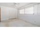 Bedroom featuring speckled floor, neutral walls, window, and large closet at 13898 Jamaica Dr, Seminole, FL 33776