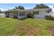 This home features a well-maintained yard, lush landscaping, and an inviting exterior at 13898 Jamaica Dr, Seminole, FL 33776