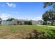 Wide view of the property showing manicured landscaping, green lawn, and charming curb appeal at 13898 Jamaica Dr, Seminole, FL 33776